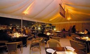 a restaurant with tables and chairs in a tent at Rampratap Palace by Fateh Collection in Udaipur