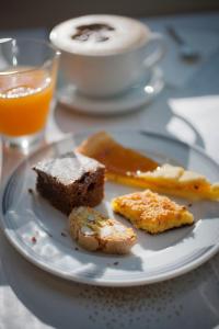 a plate of food with bread and a cup of coffee at Hotel Derby in Riccione +18 photos