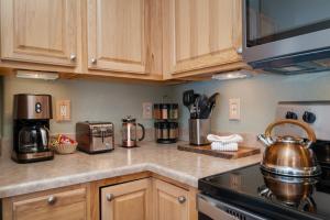 a kitchen with wooden cabinets and copper pots and pans at Waterside West A303 in Fraser