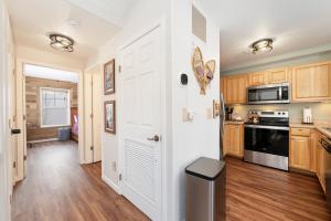 a kitchen with a white door and a stove at Waterside West A303 in Fraser +23 photos