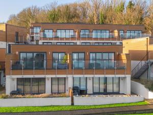 a large building with a lot of windows at Avocet 2 Luxury Apartment with Pool and Parking in Brixham