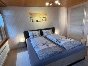 a bedroom with a large bed with two pillows at Apartment Hälmli by Interhome in Heiden +15 photos