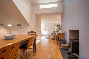 a kitchen and living room with a wooden table and chairs at Main Street No 56 - Lower Largo in Lower Largo