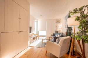 a living room with a couch and a chair at Main Street No 56 - Lower Largo in Lower Largo