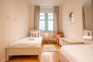a small bedroom with two beds and a window at Main Street No 56 - Lower Largo in Lower Largo