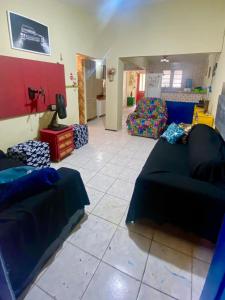 een woonkamer met een blauwe bank en een kamer met een bank bij Casa Meu Aconchego in Fortaleza