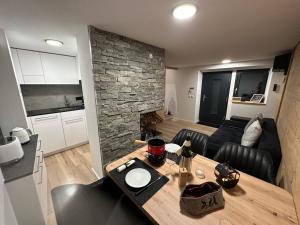 eine Küche und ein Wohnzimmer mit einem Holztisch in einem Zimmer in der Unterkunft Tiny House IBEX in Saas-Fee