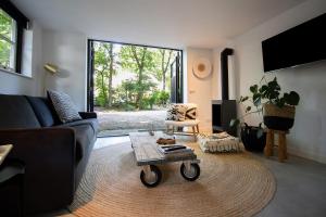 a living room with a couch and a coffee table at Forest Inn in Ugchelen