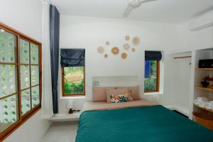 a bedroom with a green bed and windows at Neverland in Ban Tai +58 photos