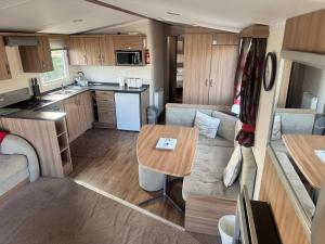 a kitchen and a living room in a caravan at The Pilot s Rest sleeps 6 in Exmouth