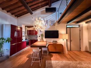 a kitchen with a table and chairs and a chandelier at Cognaia Loft in Arezzo