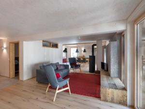 a living room with a couch and a red rug at Apartment Bellezza - Bio Bergün by Interhome in Bergün