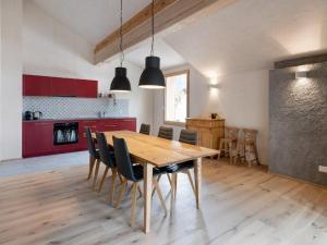 a kitchen and dining room with a wooden table and chairs at Apartment Bellezza - Bio Bergün by Interhome in Bergün