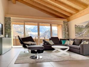 a living room with a couch and a chair at Apartment Mountain 4U by Interhome in Meiringen