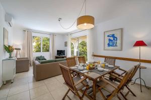 a dining room and living room with a table and chairs at Villa Casa Amelia Dio by Villa Plus in Caniço