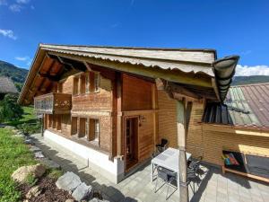 a small wooden house with a table in front of it at Holiday Home Chalet Simeli by Interhome in Grindelwald