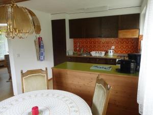 a kitchen with a table and a counter top at Apartment Akalei by Interhome in Aeschi