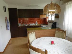 a kitchen with a table with a red candle on it at Apartment Akalei by Interhome in Aeschi