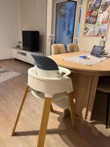 a white chair sitting in front of a table at Ferienwohnung Krautfassblick in Ortenberg