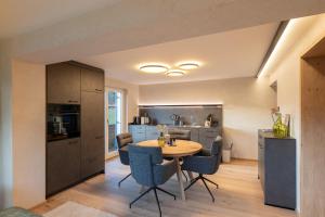 a kitchen and dining room with a table and chairs at Chalet Emely in Bartholomäberg