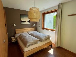 a bed in a room with a window at Apartment Chasa Ernst by Interhome in Zernez