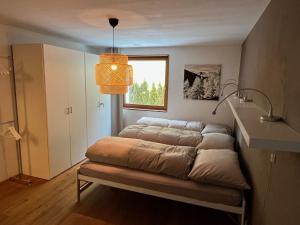 a couch sitting in a room with a window at Apartment Chasa Ernst by Interhome in Zernez