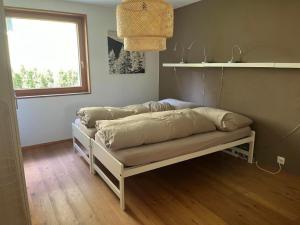 a bed sitting in a room with a window at Apartment Chasa Ernst by Interhome in Zernez