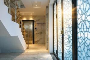 un corridoio con scala e porta a vetri di Najd Cozy Apartment a Dammam