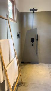 a bathroom with a towel rack with towels at The lookout lodge in Tangalle