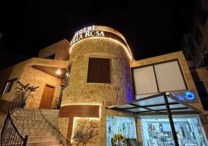un edificio con un letrero de neón encima en Villa Rosa Luxury Boutique Hotel, en Batroun