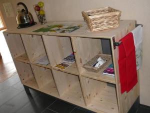 a wooden cabinet with open shelves in a kitchen at Apartment Hof Quadra by Interhome in Flerden +12 photos