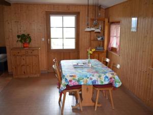 a kitchen with a table with chairs and a table cloth at Apartment Wohnung Bellevue by Interhome in Chevenez
