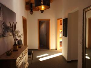 a living room with a hallway with a table and a door at Apartment La Stüerta by Interhome in Pontresina