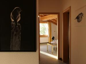 a bird sitting on a pole in a room at Apartment La Stüerta by Interhome in Pontresina +5 photos
