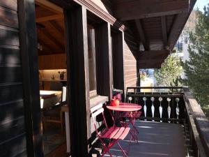 a patio with a table and two chairs on a balcony at Apartment La Stüerta by Interhome in Pontresina