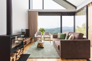 a living room with a couch and a fireplace at Casas Bouro 1 Casa Das Hortências in Terras de Bouro