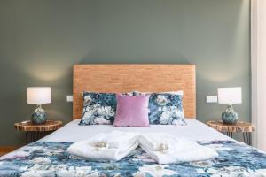 a bedroom with a bed with two pillows on it at Casas Bouro 1 Casa Das Hortências in Terras de Bouro