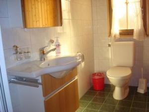 a bathroom with a sink and a toilet at Apartment Chalet Bärli by Interhome in Fiesch