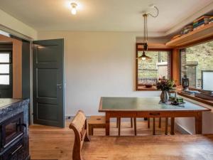 a kitchen and dining room with a wooden table at Holiday Home Eggwald by Interhome in Wassen