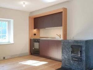 an empty kitchen with a sink and a stove at Holiday Home Eggwald by Interhome in Wassen