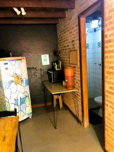a small room with a table and a toilet at Beco do Curupira Bangalô in São Luiz do Paraitinga +10 photos