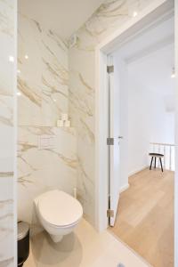 a bathroom with a white toilet in a room at Toison d'Or House 4 in Brussels