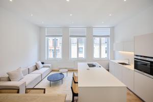 a white living room with a couch and a table at Toison d'Or House 4 in Brussels +23 photos
