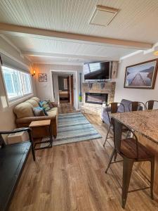 a living room with a couch and a fireplace at Aqua Aire Inn & Suites in Minocqua