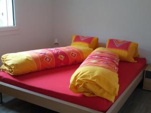 a bed with four pillows on top of it at Apartment Schwändelifluh by Interhome in Flühli