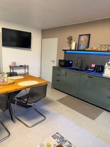 una cucina con un tavolo di legno e un lavello di Tiger Apartment a Sinsheim Altre 25 foto
