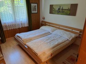a bed in a bedroom with a picture on the wall at Apartment Bijou by Interhome in Alt Sankt Johann