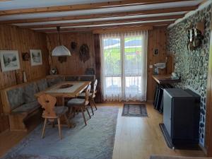 a living room with a wooden table and a television at Apartment Bijou by Interhome in Alt Sankt Johann