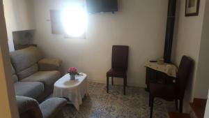 a living room with a couch and a table at Casa La Arracada in Villena