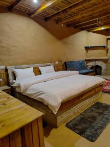 a bedroom with a large bed in a room with a fireplace at Nandi Roop Homestay in Panuānaula